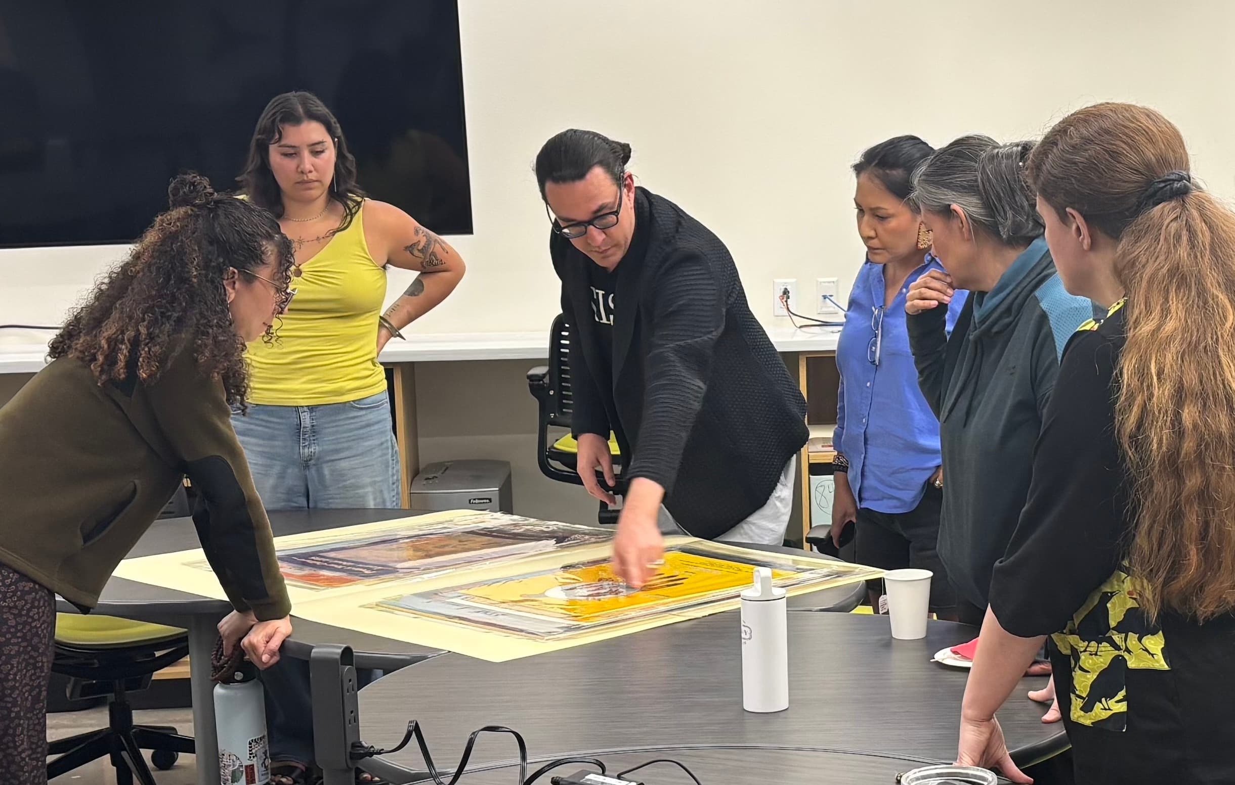 Brian and others looking at posters in an archive